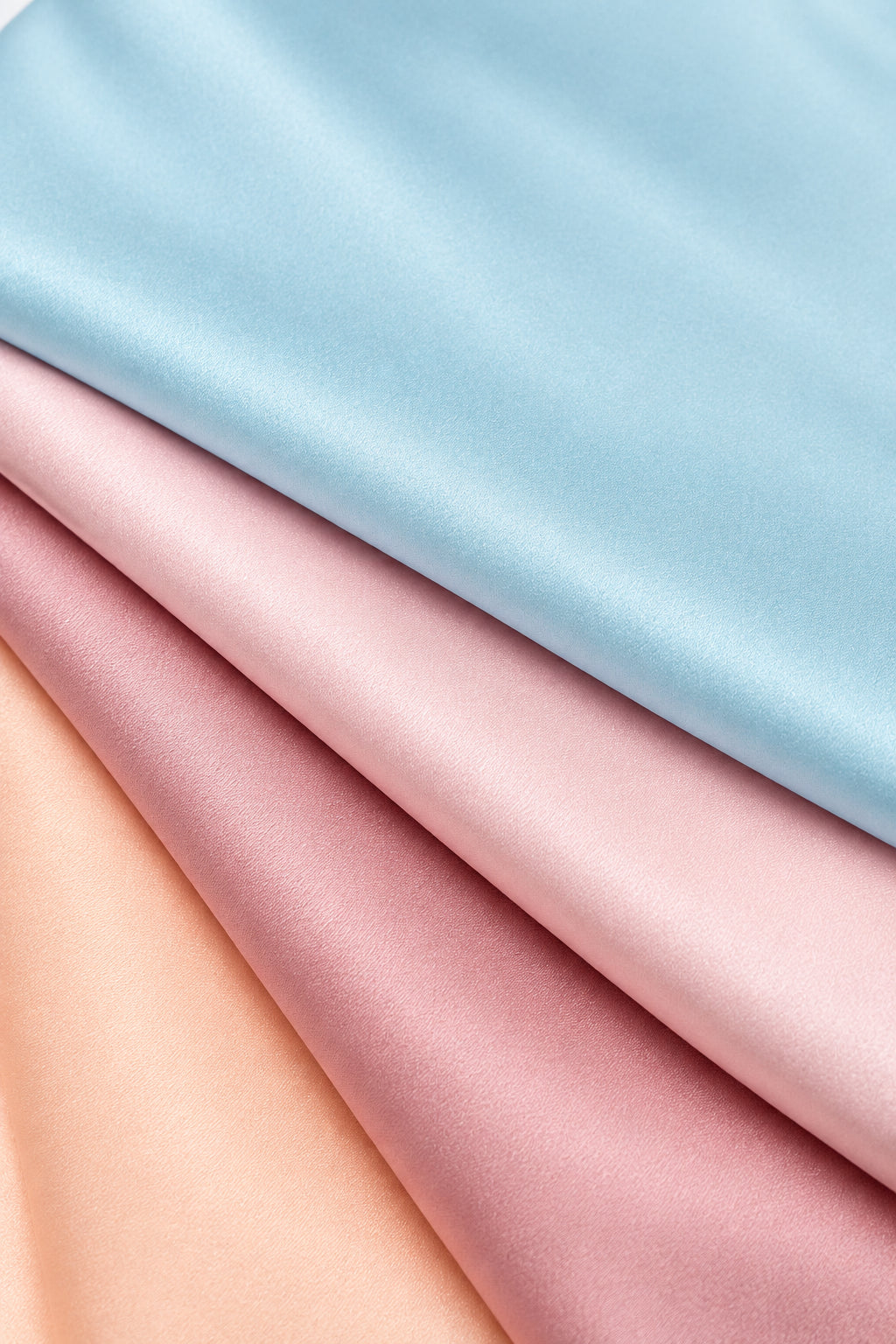 Close-up of premium 6A silk texture on a baby blue blanket, ultra-soft, breathable and eco-friendly.