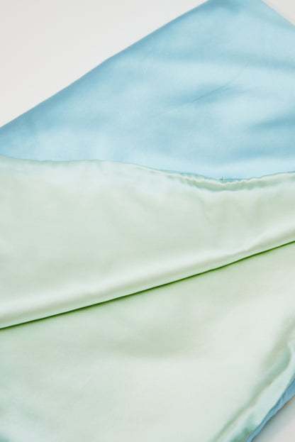 Close-up of premium 6A silk texture on a baby blue blanket, ultra-soft, breathable and eco-friendly.