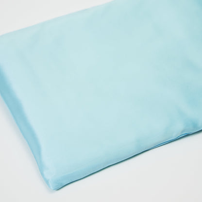 Close-up of premium 6A silk texture on a baby blue pillow, ultra-soft, breathable and eco-friendly.