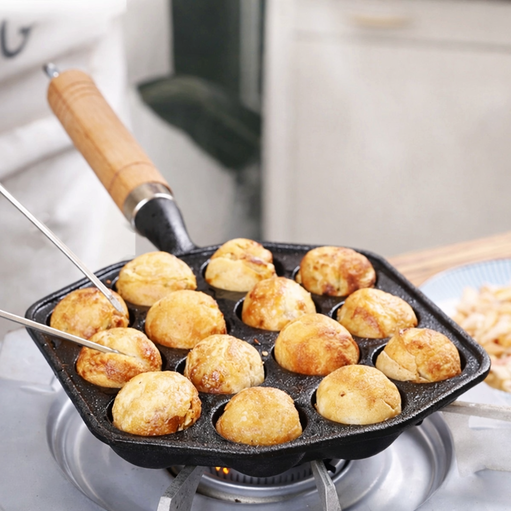 Small frying pan with golden-brown food items on a stove