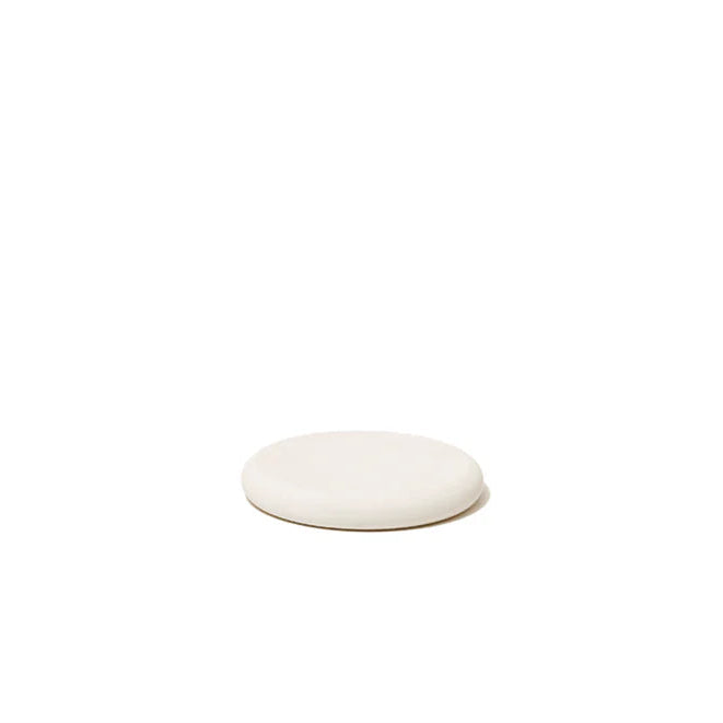 Quick drying round soap dish made from diatomaceous earth.