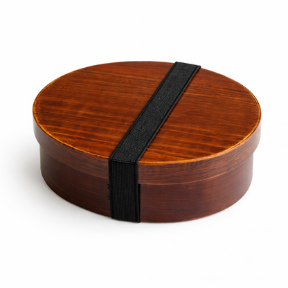 Wooden bento box with a black strap on a white background