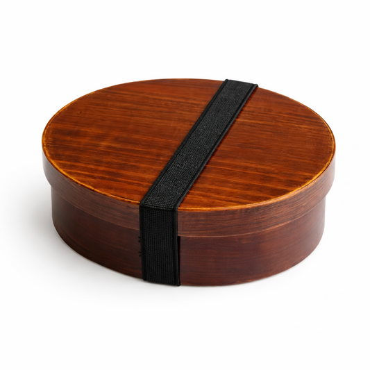 Wooden bento box with a black strap on a white background