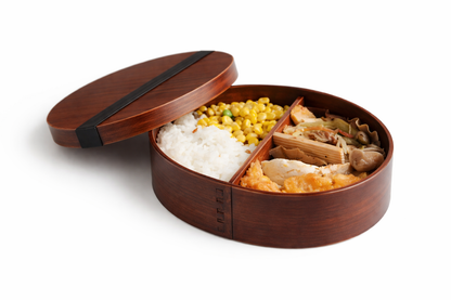 Wooden bento box with compartments filled with food on a white background