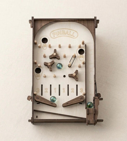 Retro DIY wooden pinball machine with glass marbles displayed on a tabletop