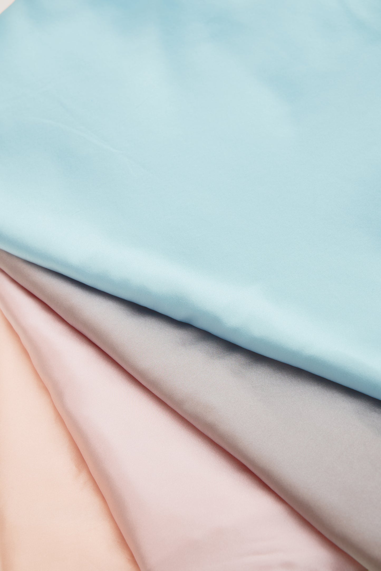 Close-up of premium 6A silk texture on a baby blue blanket, ultra-soft, breathable and eco-friendly.