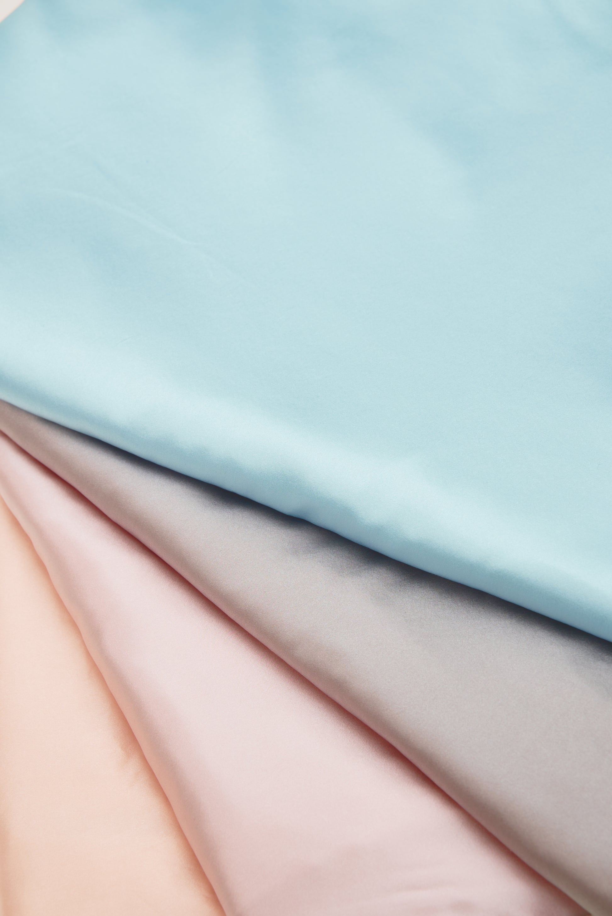 Close-up of premium 6A silk texture on a baby pink blanket, ultra-soft, breathable and eco-friendly.
