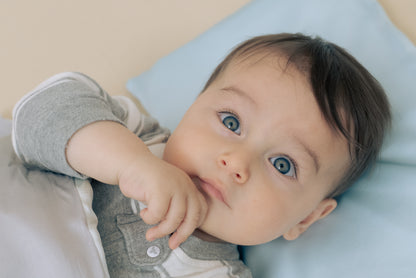 Premium 6A silk baby pillow in baby blue styled on a cozy nursery bed, smooth, breathable, vegan and sustainable