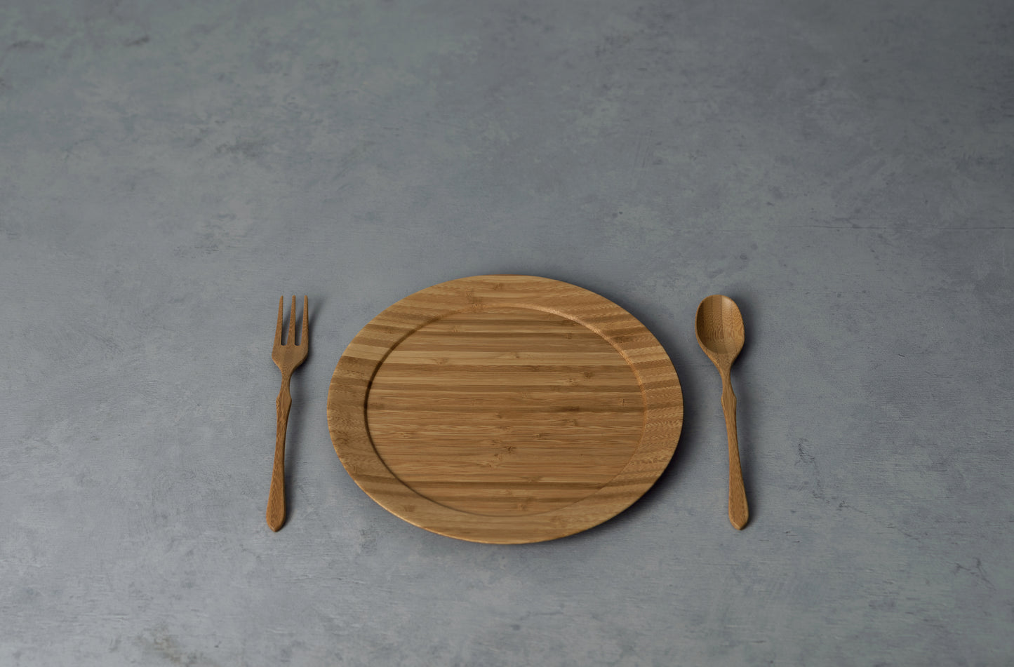 Sustainable  bamboo wooden plate on a rustic table.