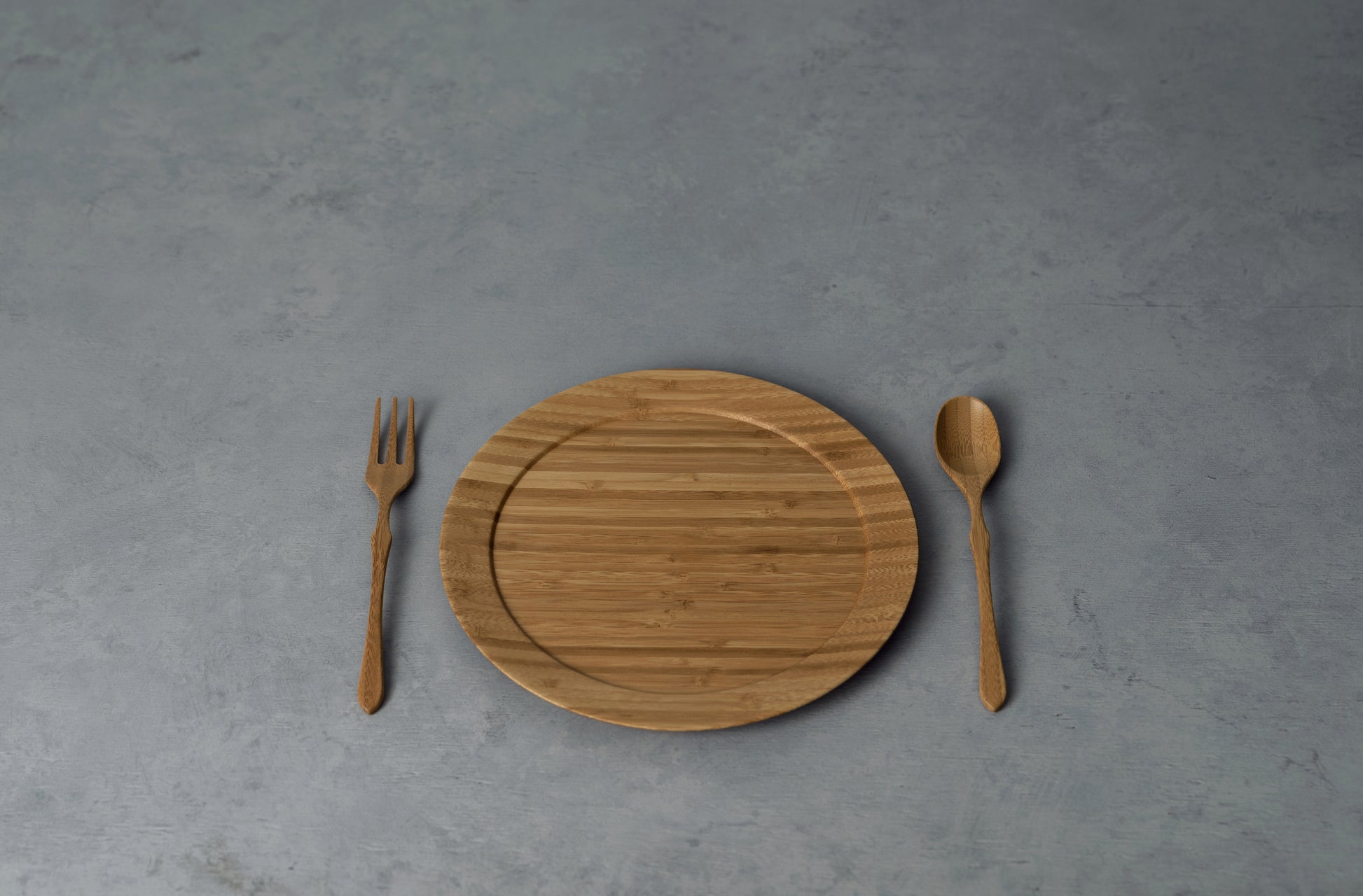 Sustainable  bamboo wooden plate on a rustic table.