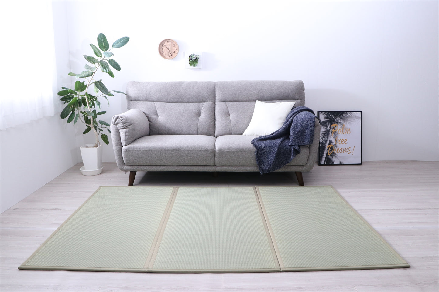 Tatami foldable mattress in Three placed in a minimalist living space, crafted from natural igusa grass, vegan and eco-friendly.